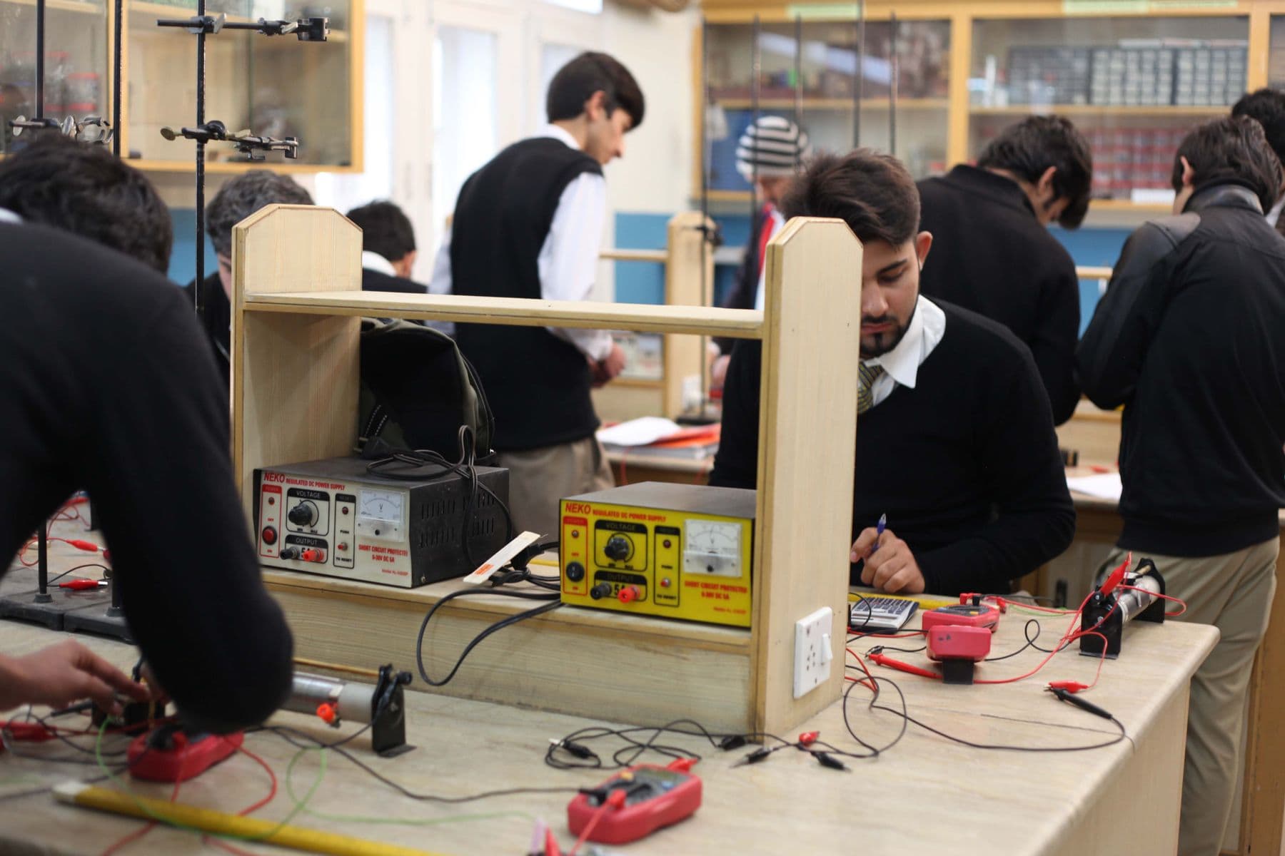 Students working with electronics at a lab bench