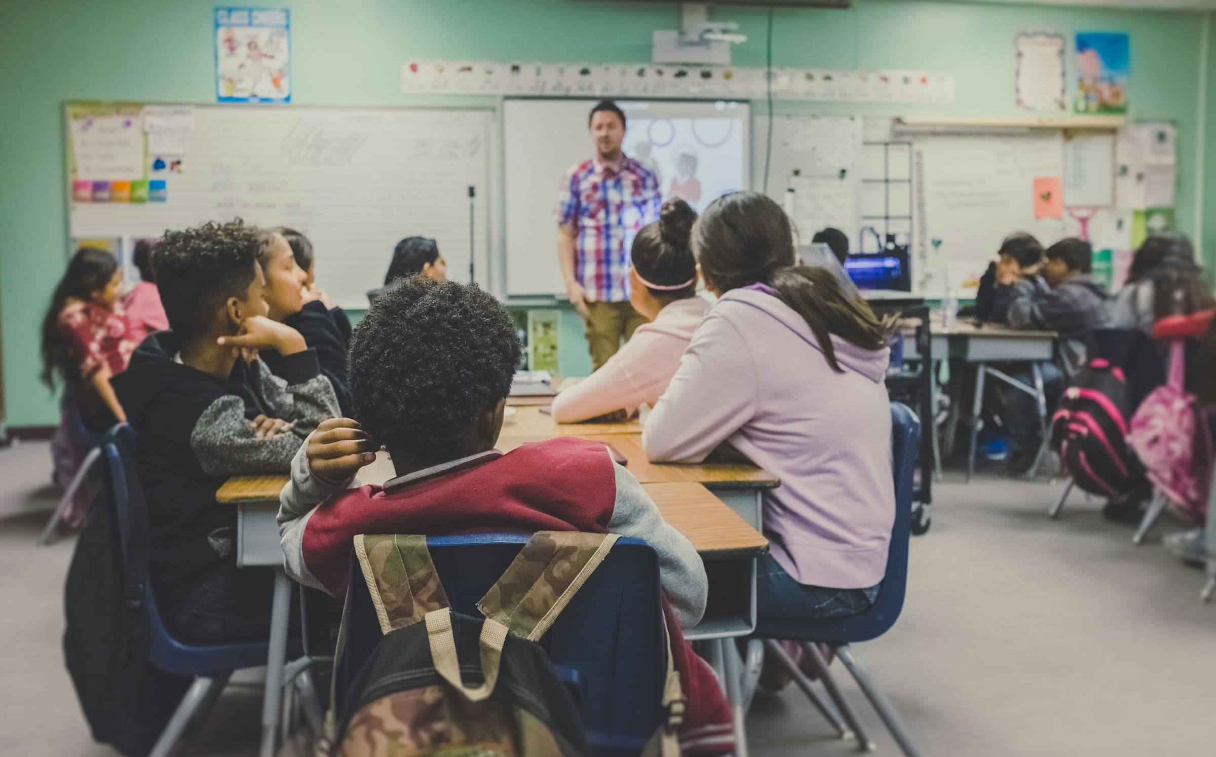 A teacher presenting to students in a classroom